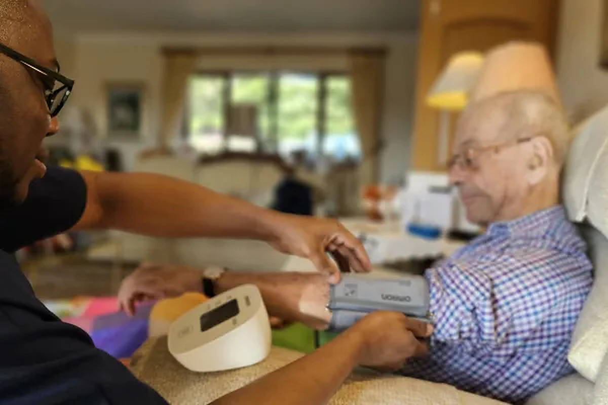 See Fresh Springs Care on homecare.co.uk Fresh Springs Care carer taking an elderly man's blood pressure in a home setting