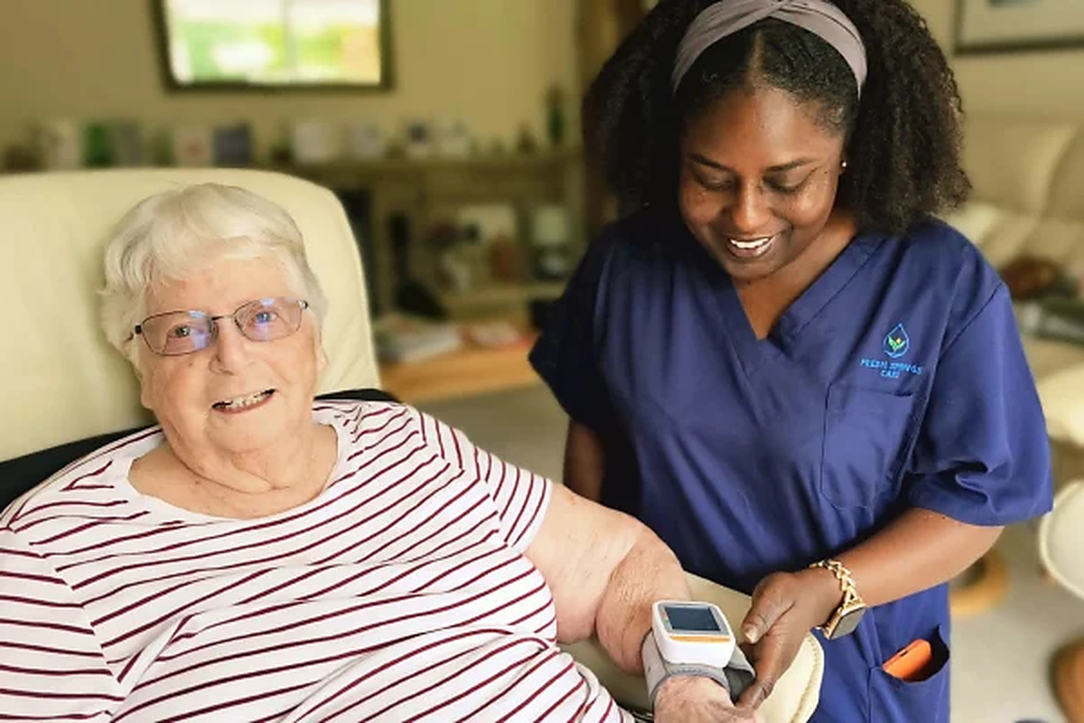 See Fresh Springs Care on homecare.co.uk Fresh Springs Care carer checking an elderly woman's blood pressure at home