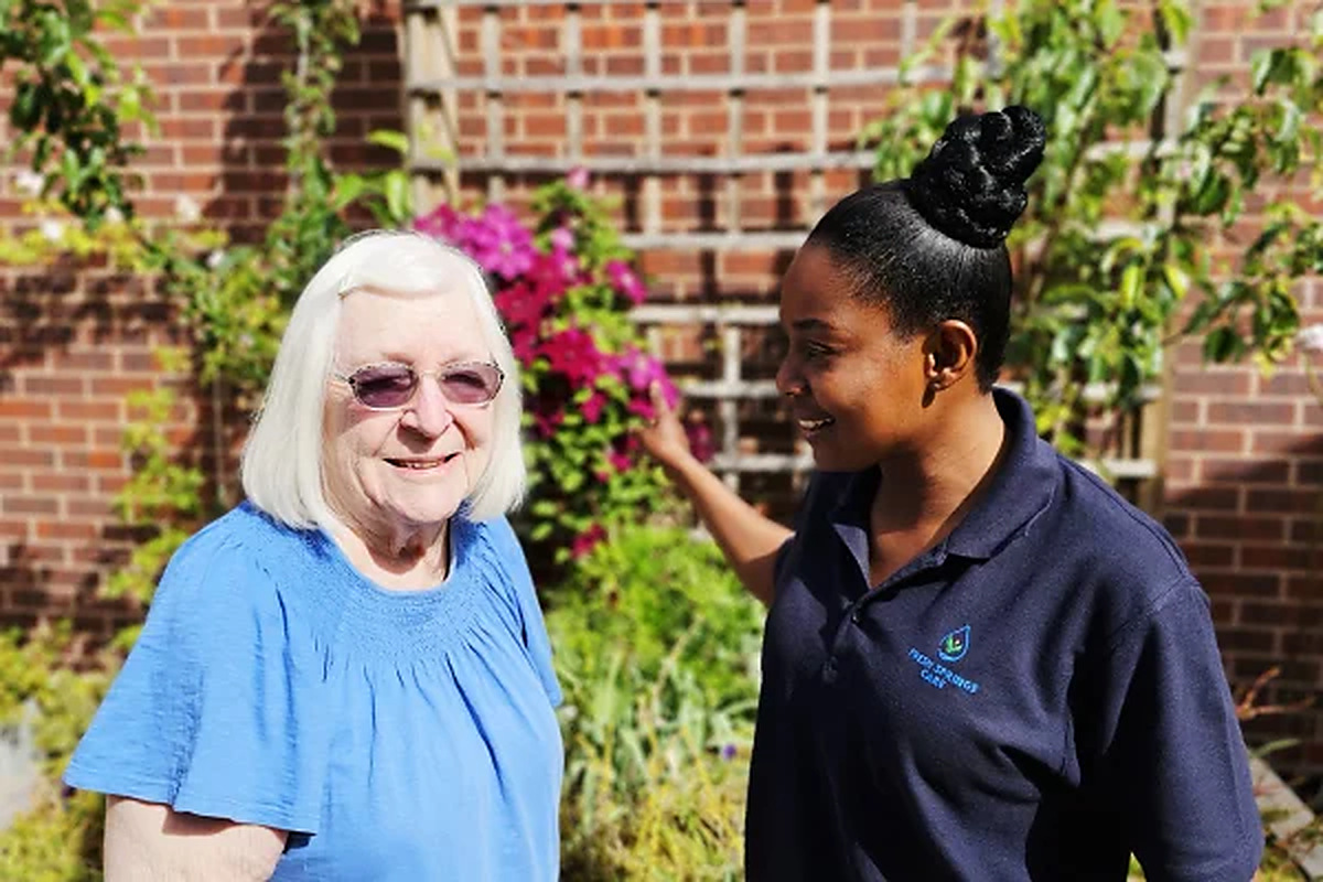 See Fresh Springs Care on homecare.co.uk Fresh Springs Care carer standing outdoors with an elderly woman in a garden